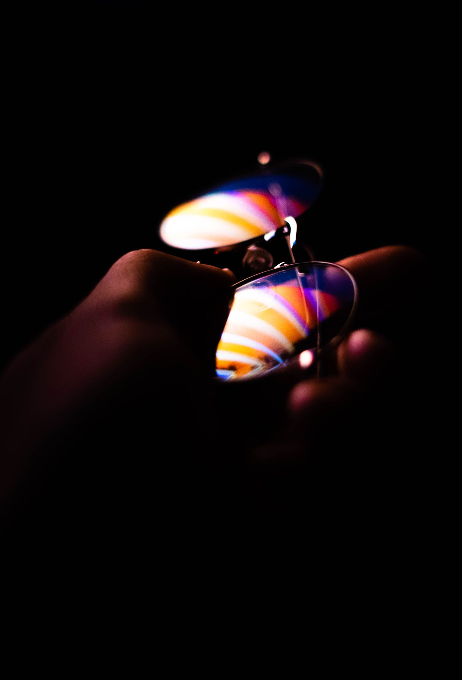 Holographic lens held to the light, showing a rainbow refraction