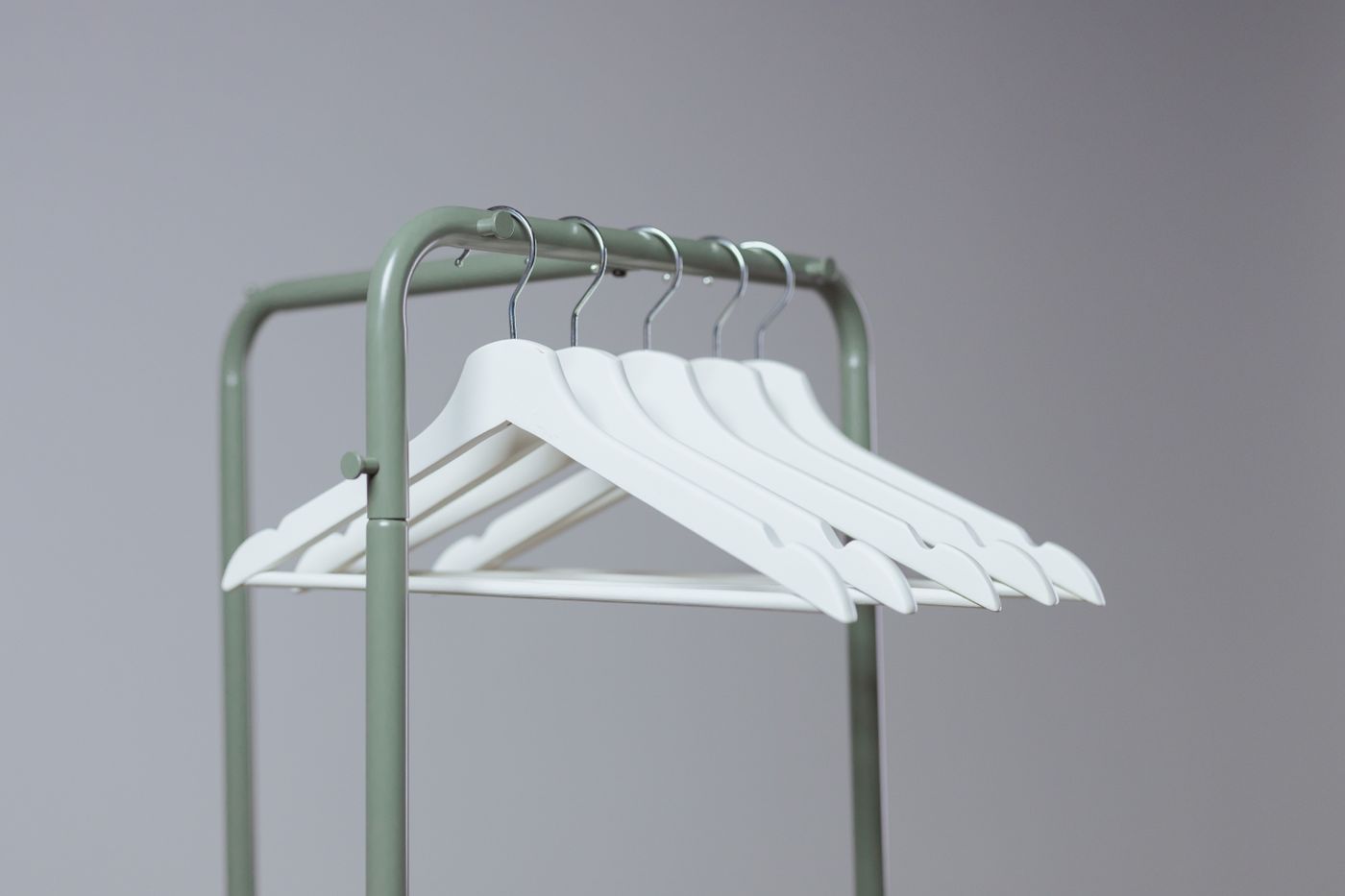 An empty garment rail with hangers in a quiet room
